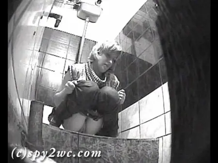 Une caméra cachée dans les toilettes d'une boîte de nuit tourne comme des femmes percées
